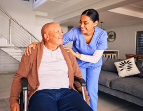 Caregiver and elderly smiling