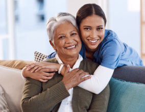 Caregiver hugging elderly