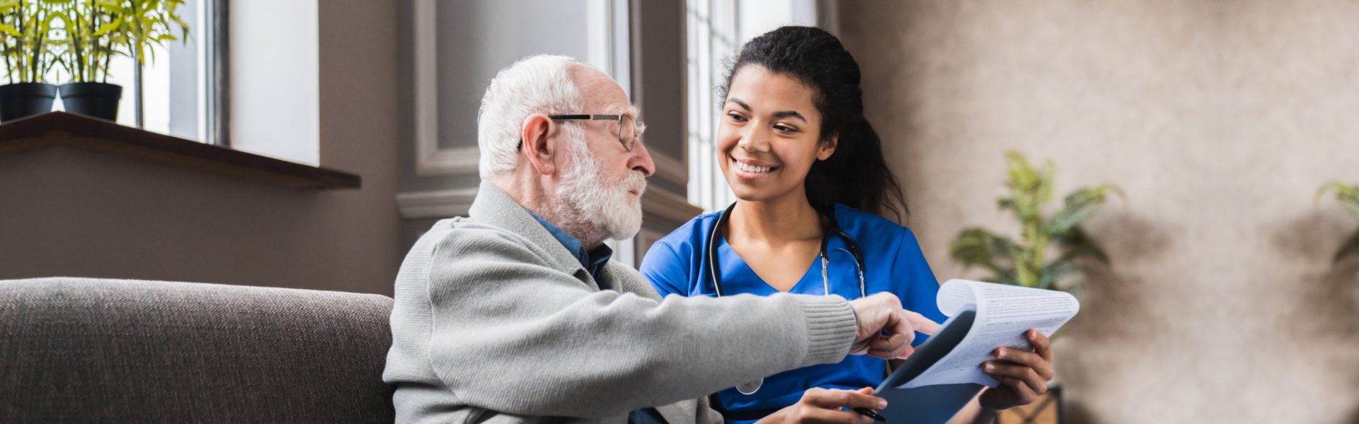 Caregiver and elderly reading