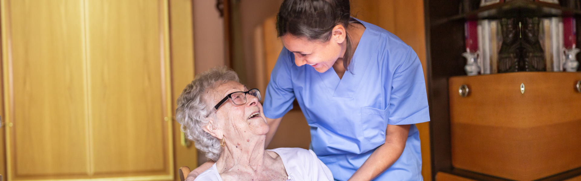 Caregiver and elderly smiling